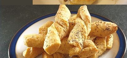 Twisted cheese straws sprinkled with poppy seeds